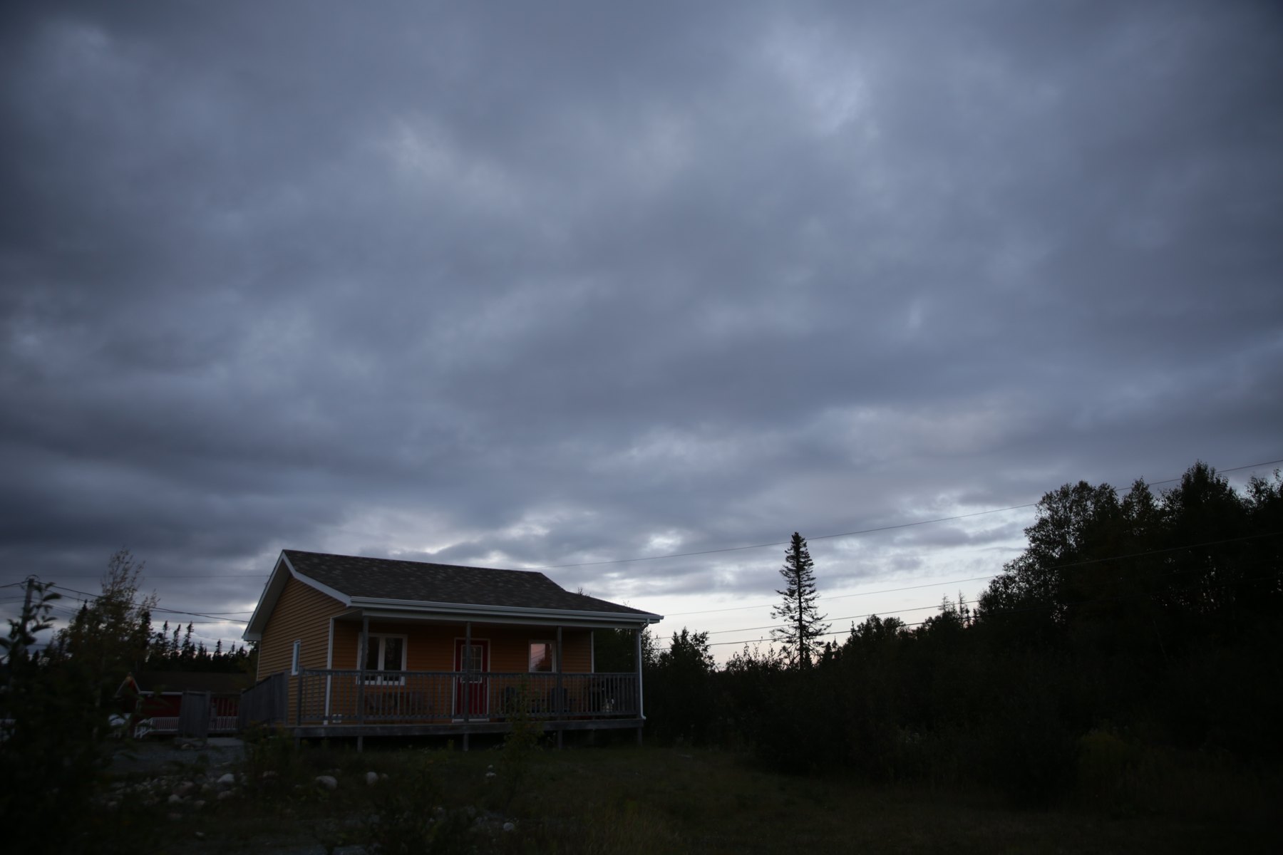A cabin under an evening sky